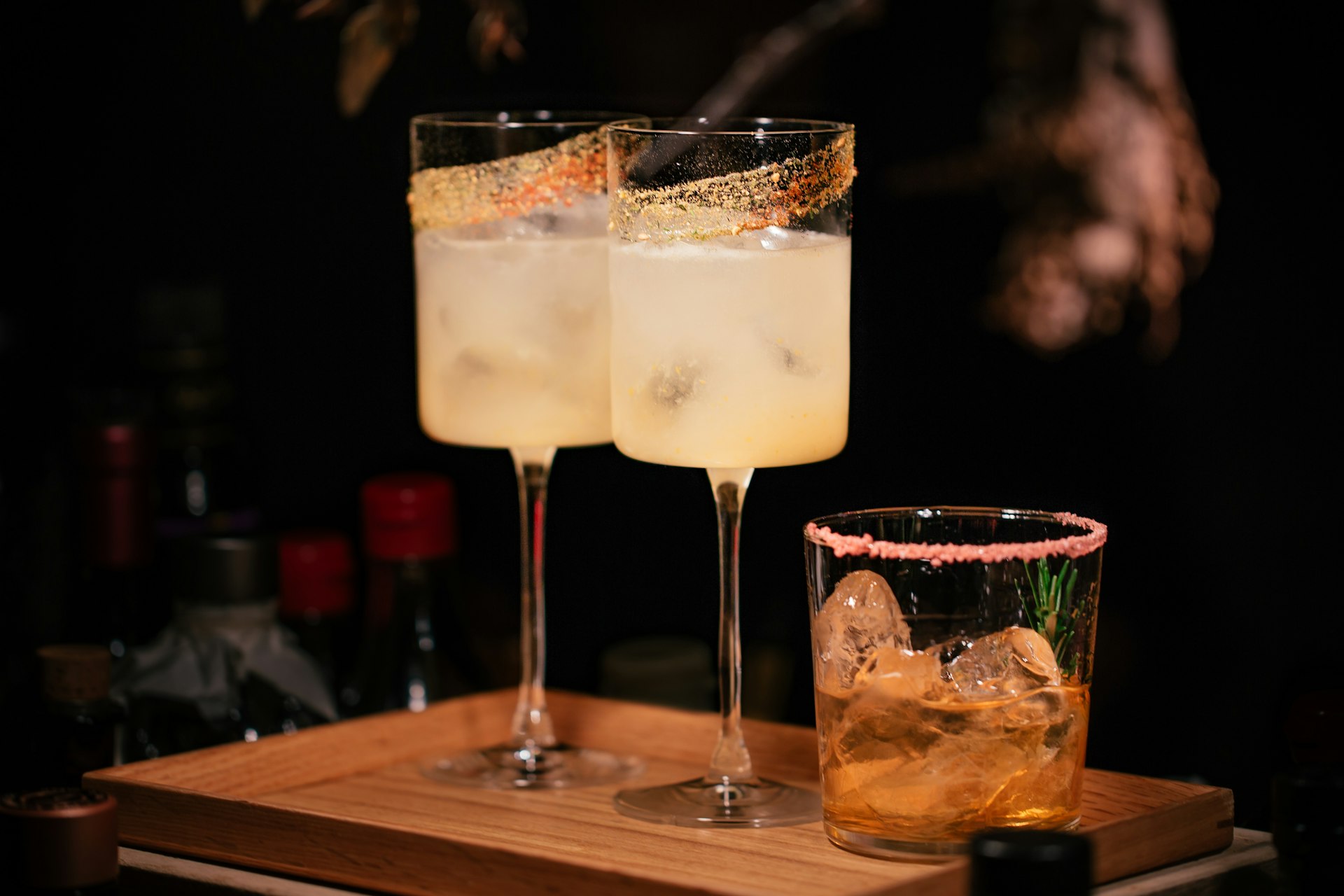 liquor filled wine glasses and rock glass